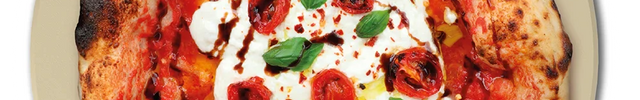 A pizza sits on the Revolve oven's rotating stone.